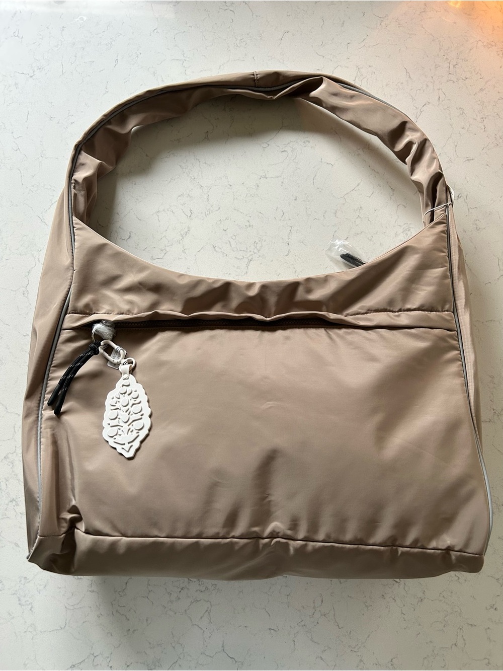 New FP Movement Tempo Puffer Carryall in Ginger Root with New Buti Keychain